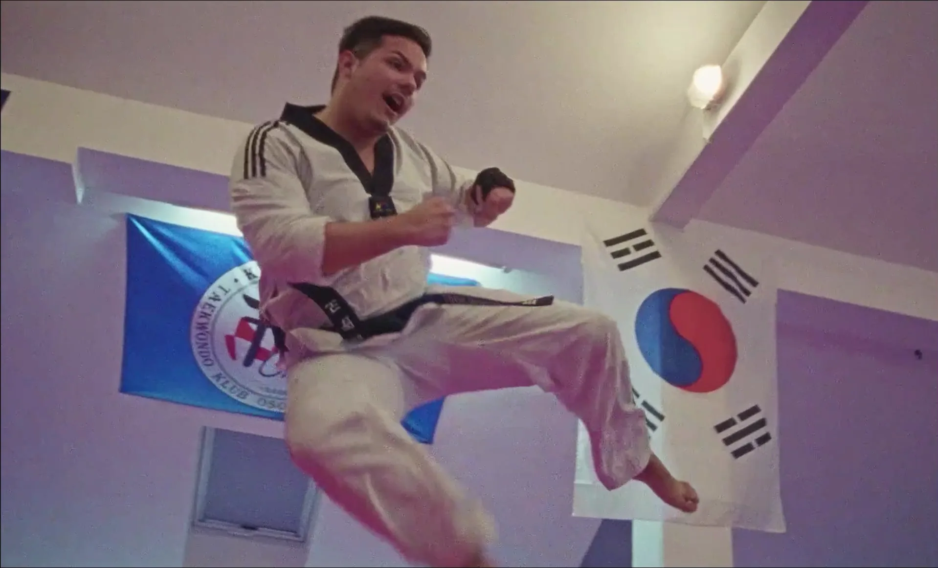 Blackbelts — a Para Taekwondo athlete airborne in a jumping kick during training.